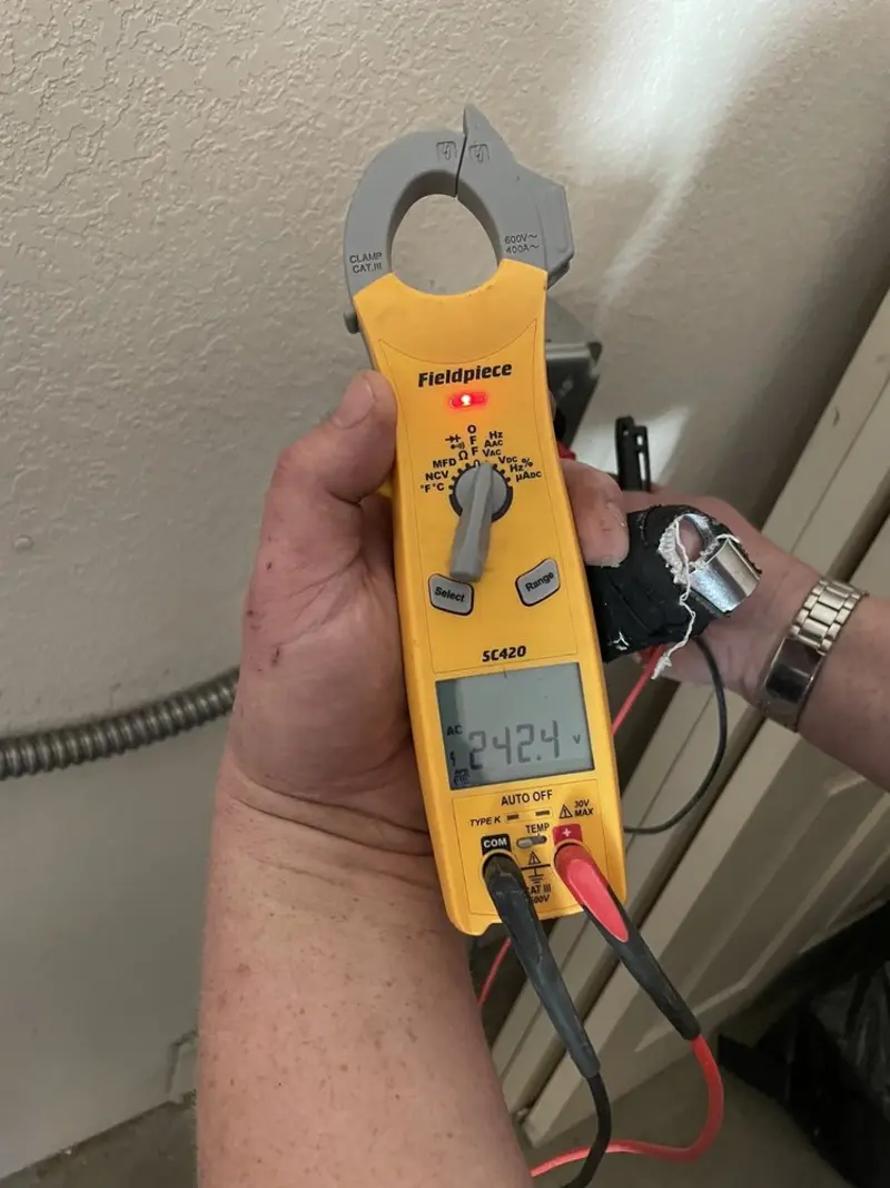 Voltage testing with clamp meter during Ceiling Fan Installation in Hopedale